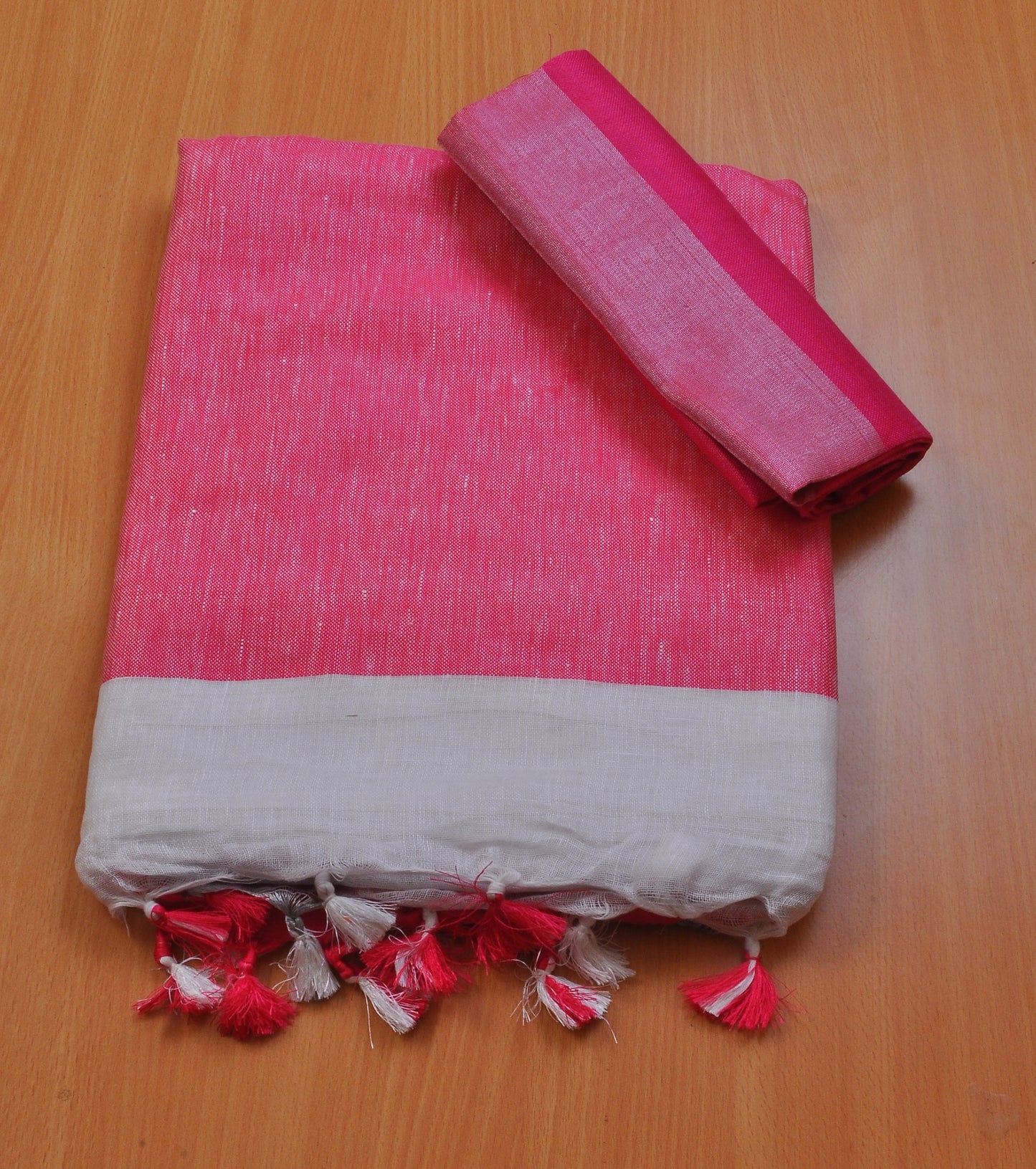 Off-white linen saree with pink pallu and border