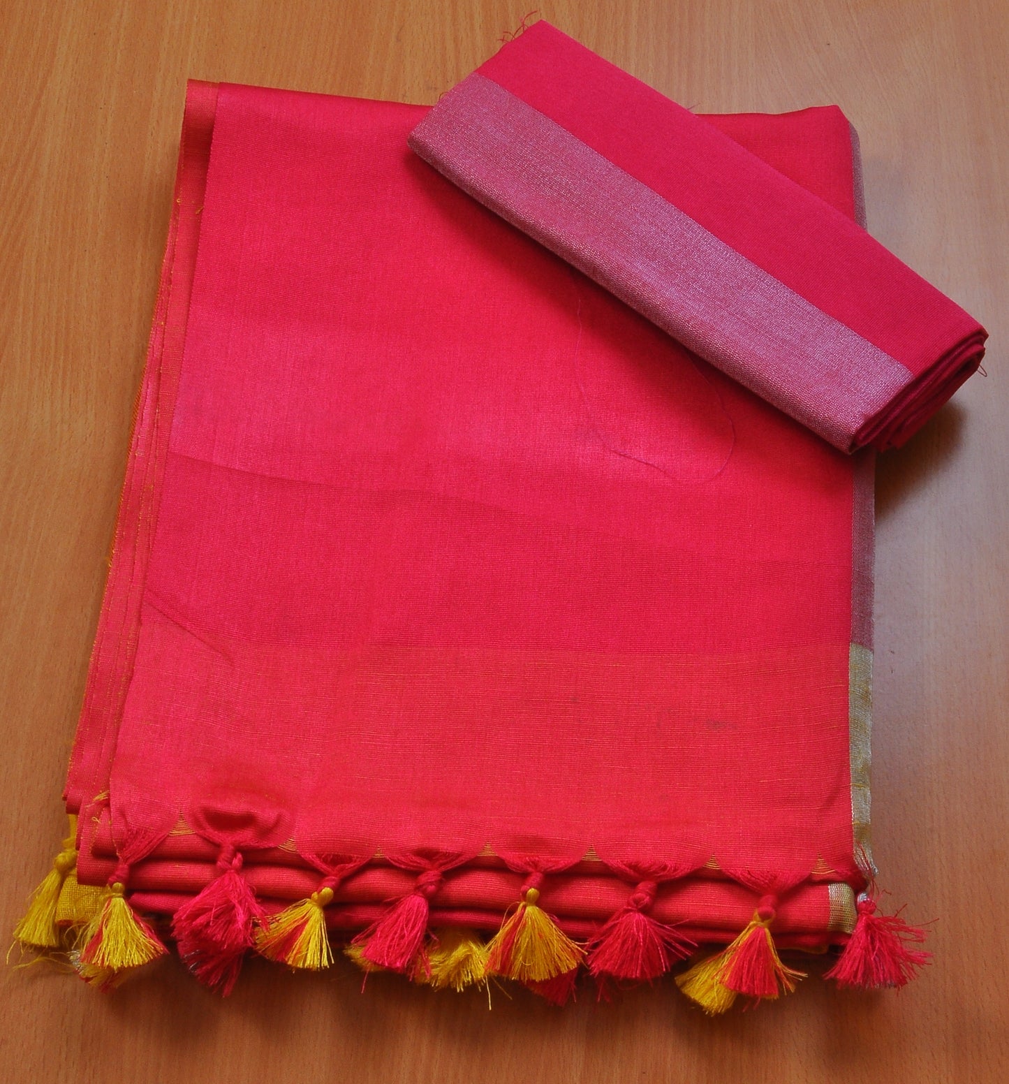 Yellow linen saree with dark pink pallu and border