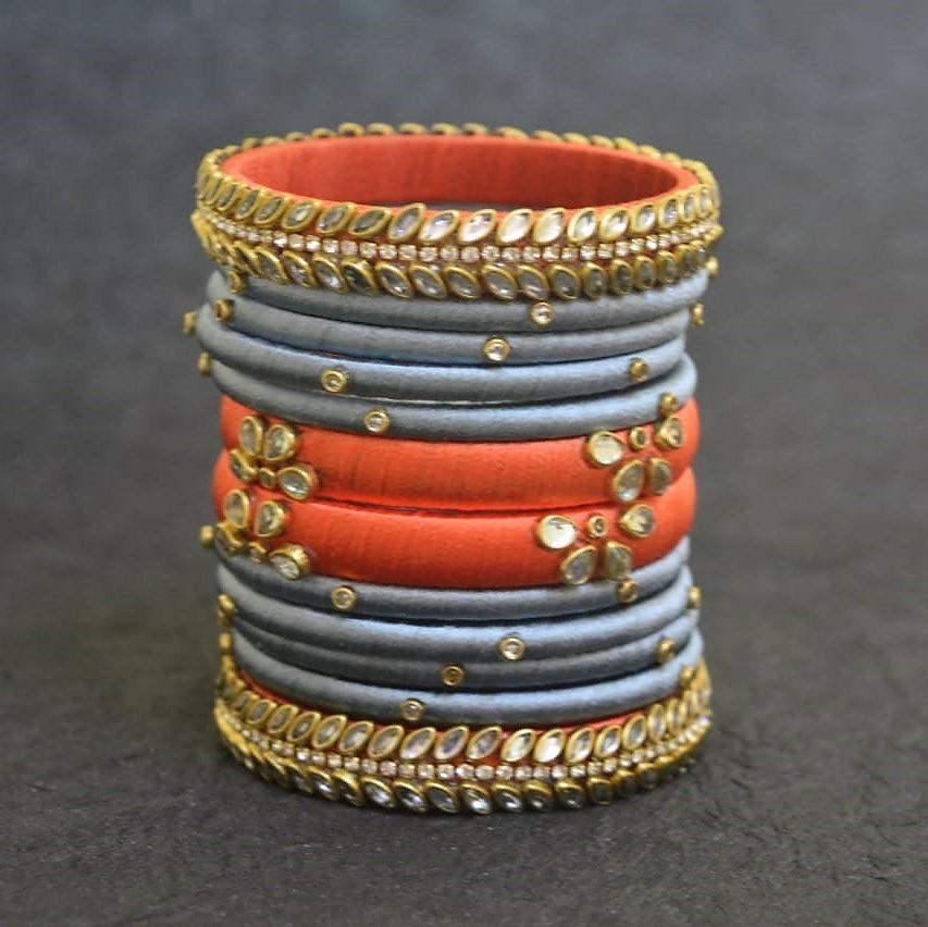 Grey with orange kundan work silk thread bangles